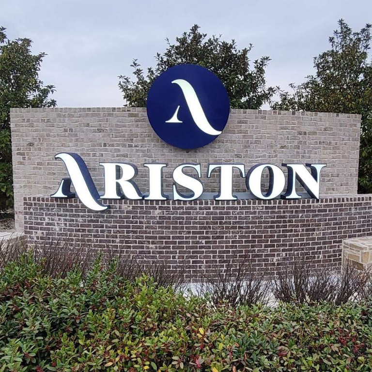 Masonry monument sign with brick, stone base, and custom Ariston lettering