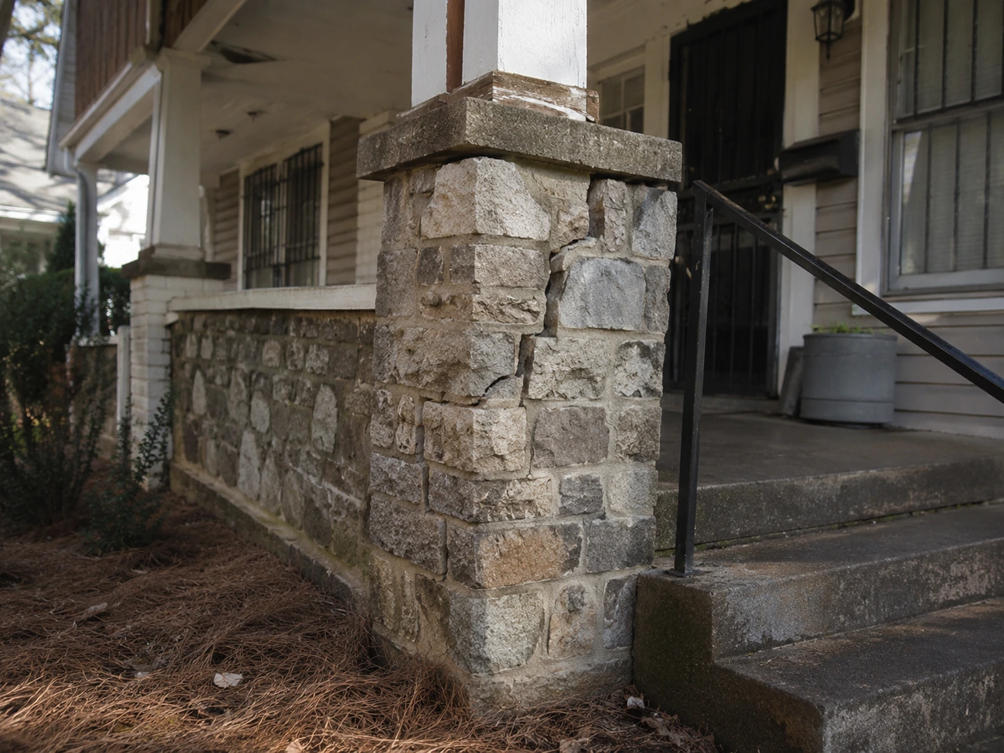 Cracked stone porch pier on a 1920s bungalow in East Point, Georgia