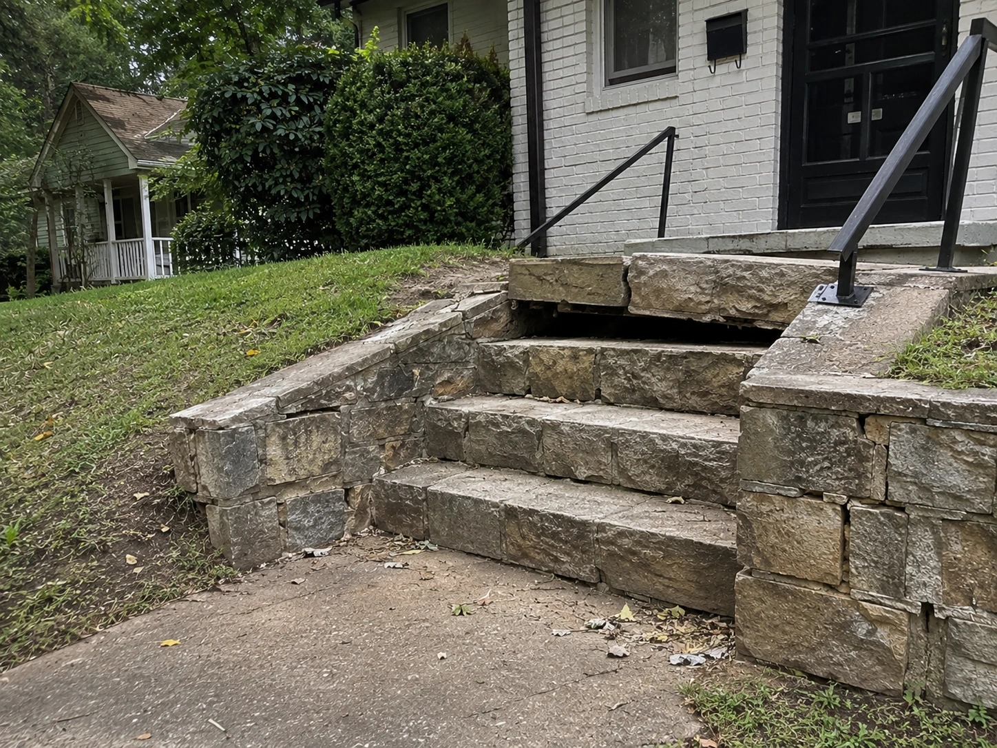 Cracked stone stoop and tilted step on an older Red Oak property in South Fulton