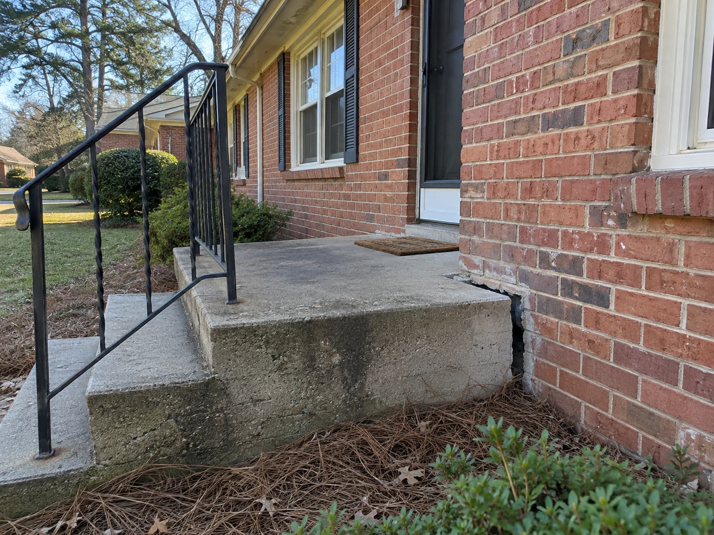 Front stoop separating from a 1950s brick ranch in Belvedere Park