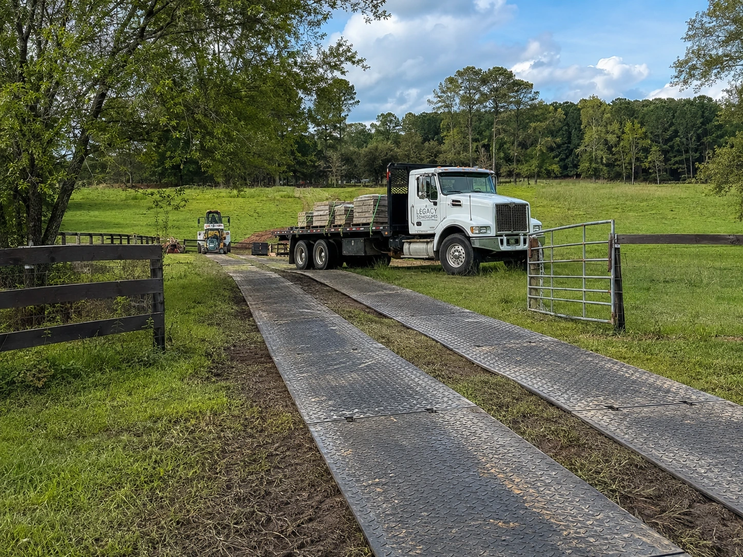 Ground mats protecting a pasture track during a stone delivery in Cedar Grove