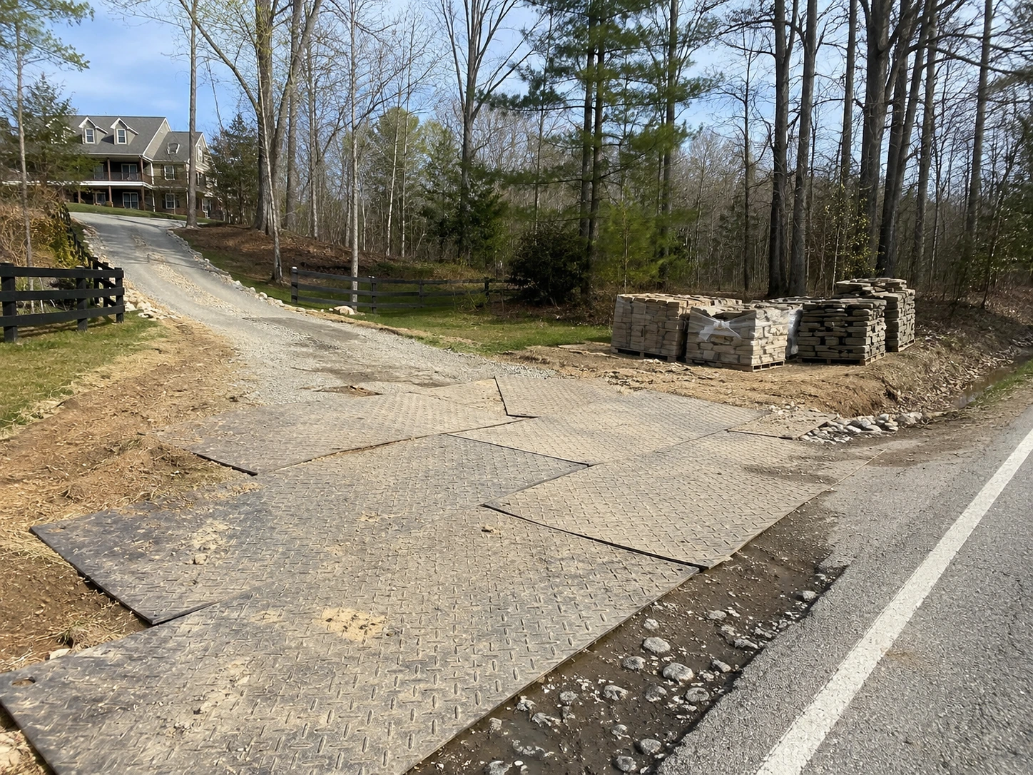 Mats at a ditched driveway turn-in during a stone delivery in Cliftondale
