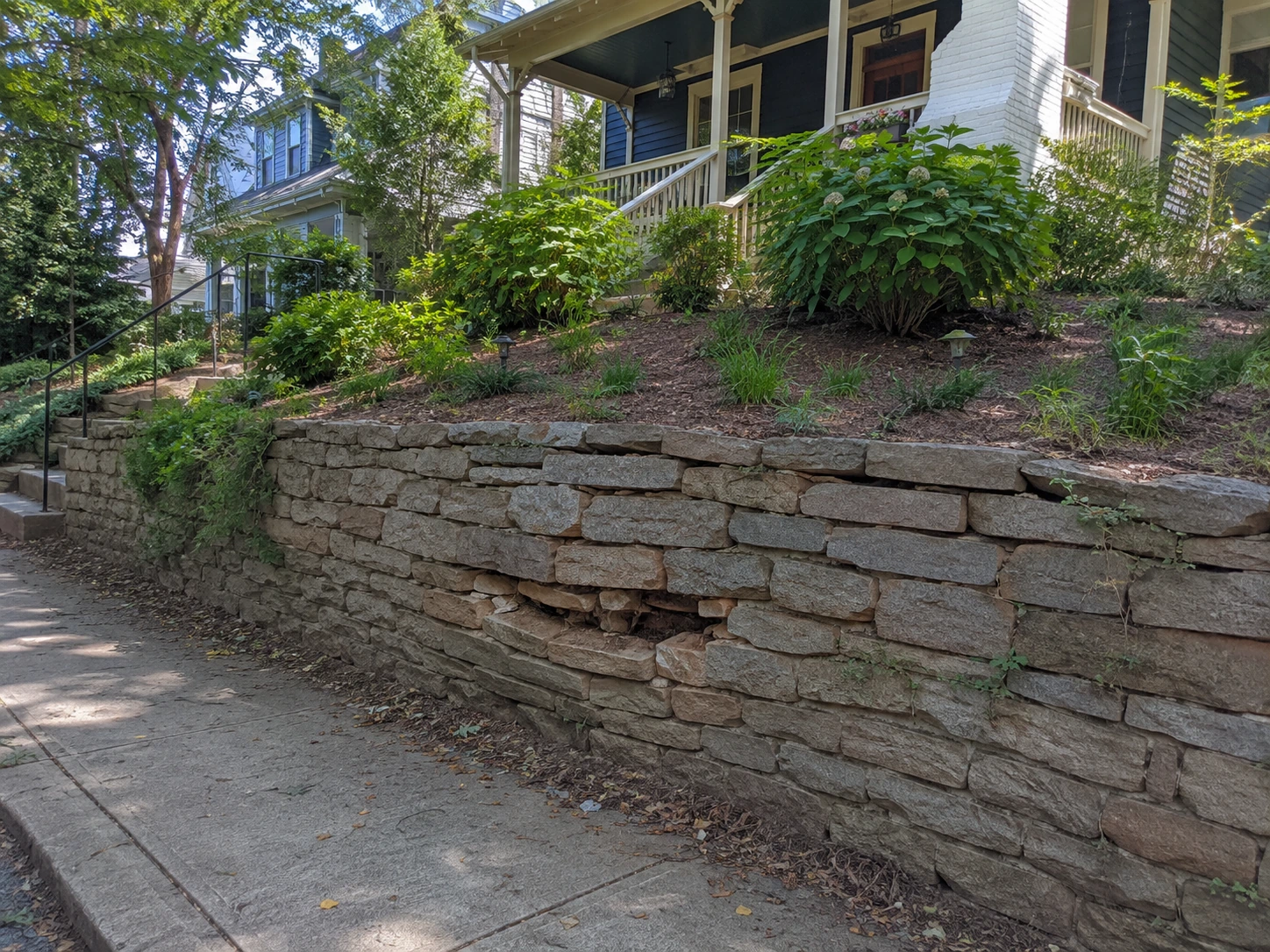 Bulging terraced front retaining wall on a Virginia-Highland lot in Atlanta